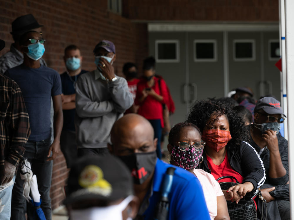 People wait in line on the first day of early voting for the 2020 general election on Oct. 12 in Atlanta.