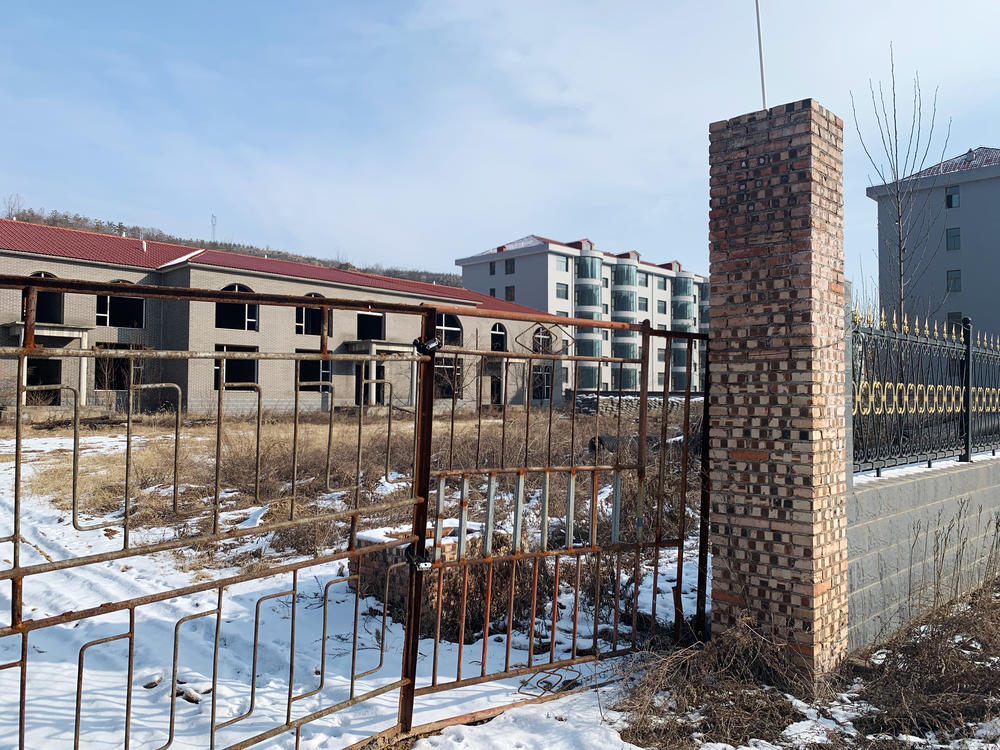 According to Zhang Zhixiong's family, Juxin Mining Co. paid for several village infrastructure projects, including building new apartment complexes for local residents. The buildings were weeks away from completion before Zhang was arrested and now stand abandoned in the middle of the village.