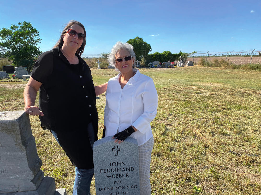 Roseann Bacha-Garza (left), a borderlands historian, stands with Olga Webber-Vasques at the grave of the latter's great-great-grandfather, the abolitionist John Ferdinand Webber, in the family cemetery.