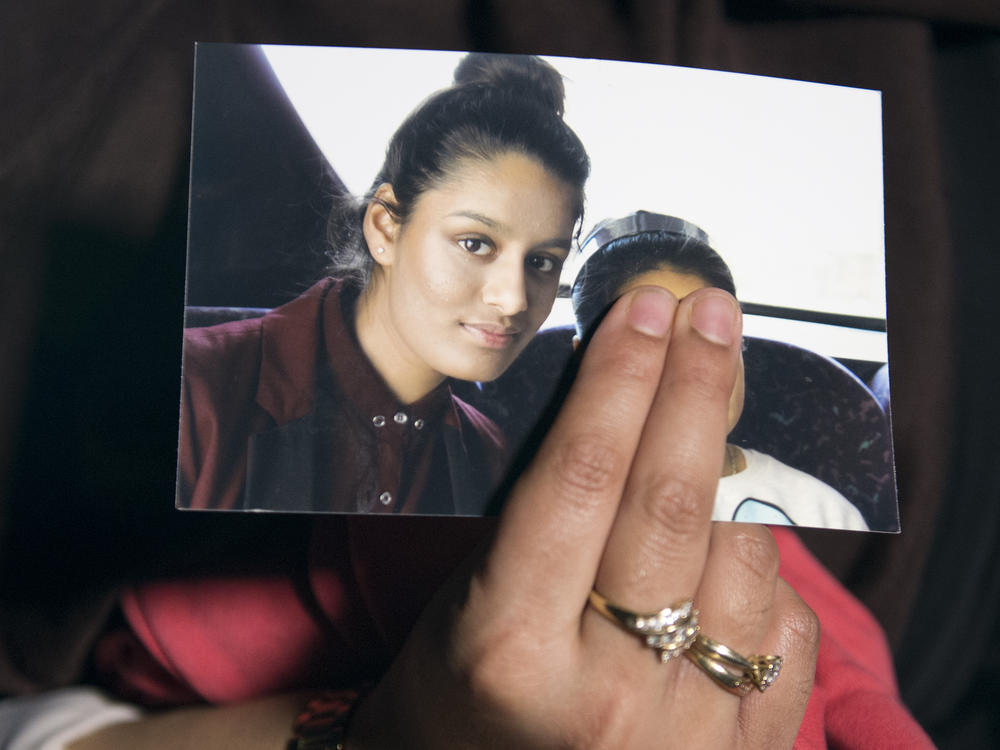 Renu Begum, eldest sister of Shamima Begum, holds her sister's photo as she is interviewed by the media at New Scotland Yard. The U.K. revoked Shamima Begum's British citizenship two years ago, citing security concerns.