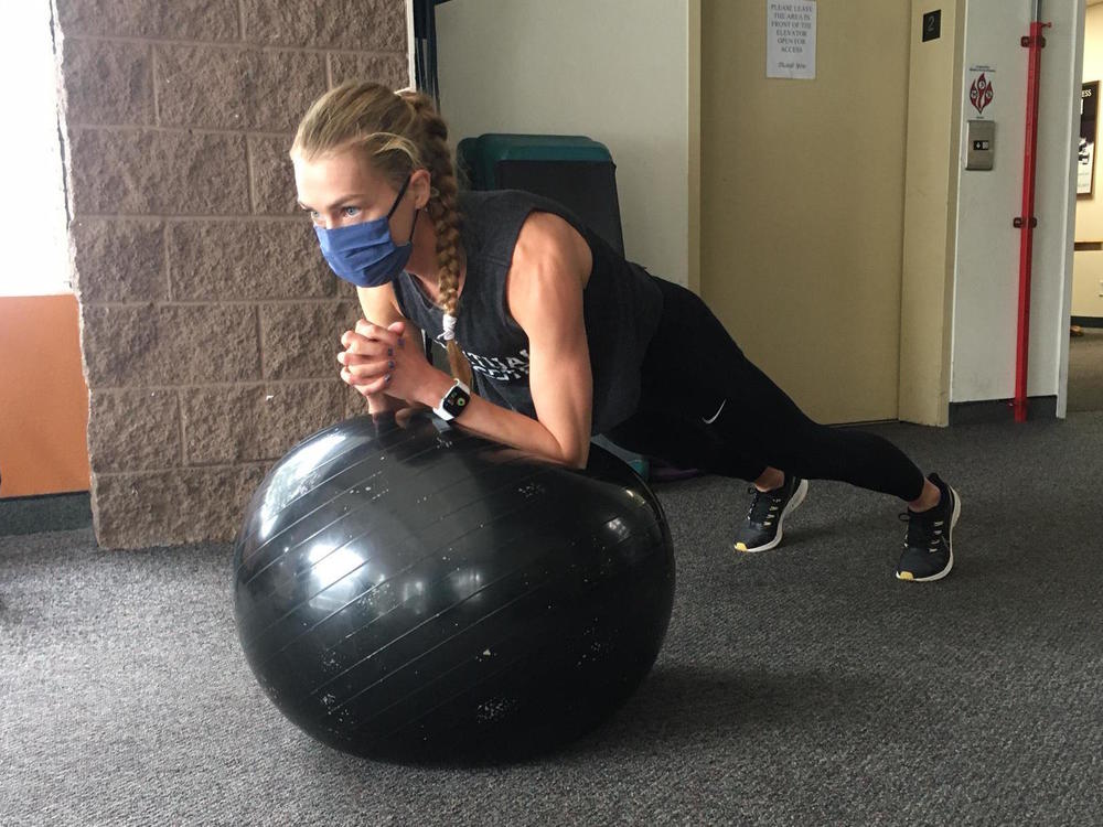 Colleen Quigley stretches before a workout in Flagstaff, Ariz. She spent several weeks training at high altitude. She's trying not to focus on the uncertainty of the Games.