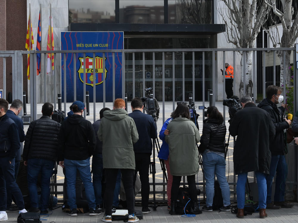 Journalists line the front gate of FC Barcelona offices on Monday during a police operation inside.