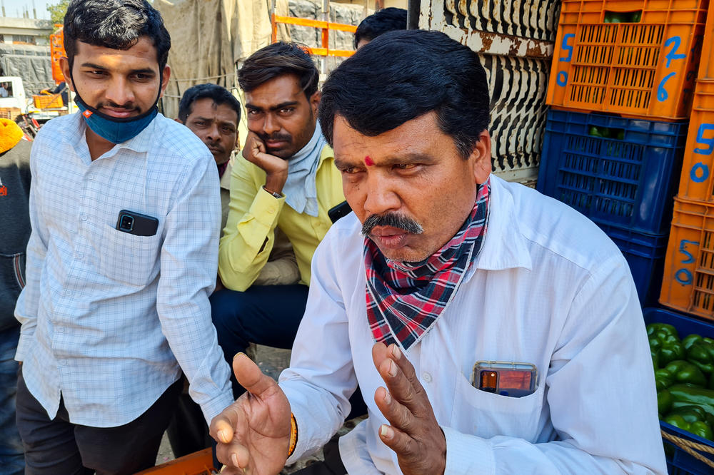 Farmer Ambadas Sanap, a plaid bandana around his neck and a Hindu mark of devotion on his forehead, grows tomatoes and bell peppers. He says he'd participate in the protests — except he's too busy trying to sell his crops to feed his family of 9.