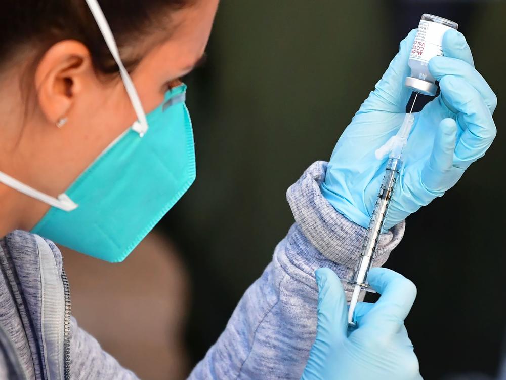 A health care worker draws a dose of Moderna's COVID-19 vaccine into a syringe for an immunization event in the parking lot of the L.A. Mission on Feb. 24.