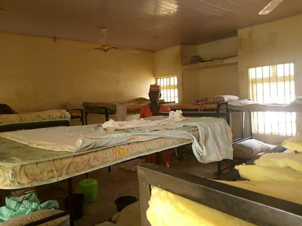 A man stands in the deserted school dormitory after gunmen invaded and took away more than 270 girls in Jangebe in northwest Nigeria, on Feb. 26. The girls have all since been returned.