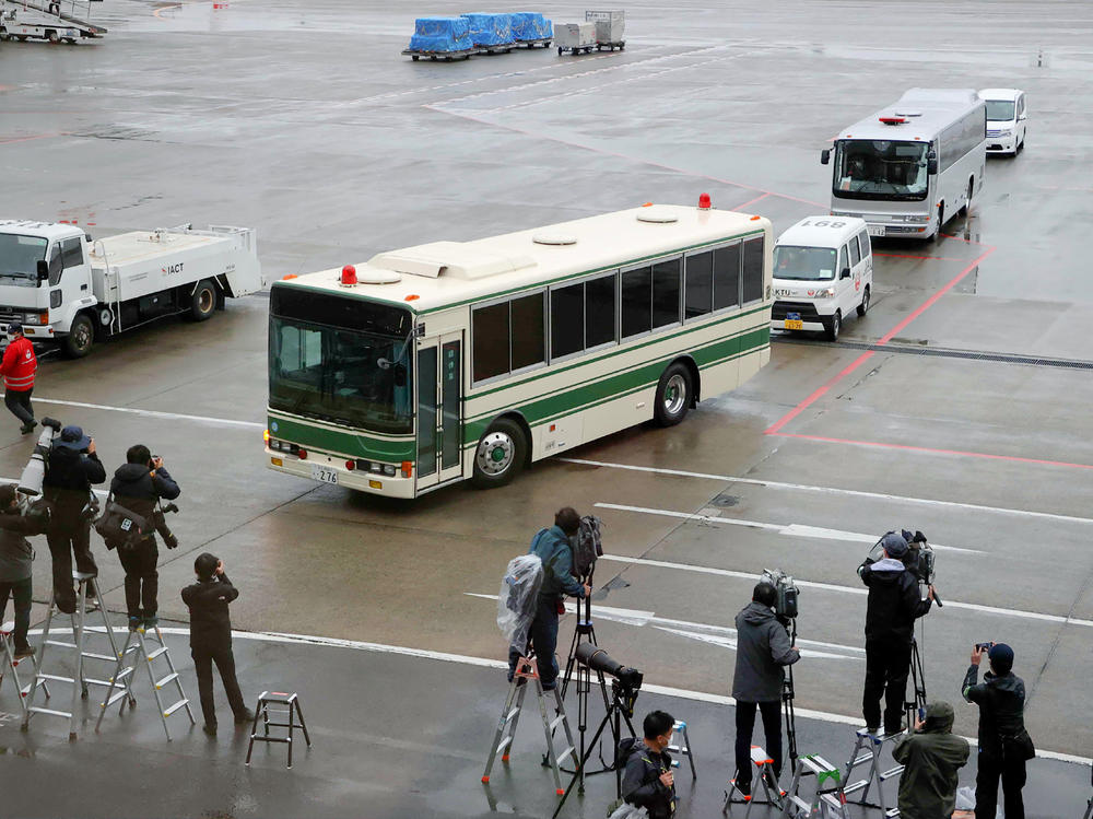 A bus believed to be carrying former U.S. special forces member Michael Taylor and his son Peter, who allegedly staged the operation to help fly former Nissan chief Carlos Ghosn out of Japan in 2019, leaves Narita International Airport in Japan on Tuesday.