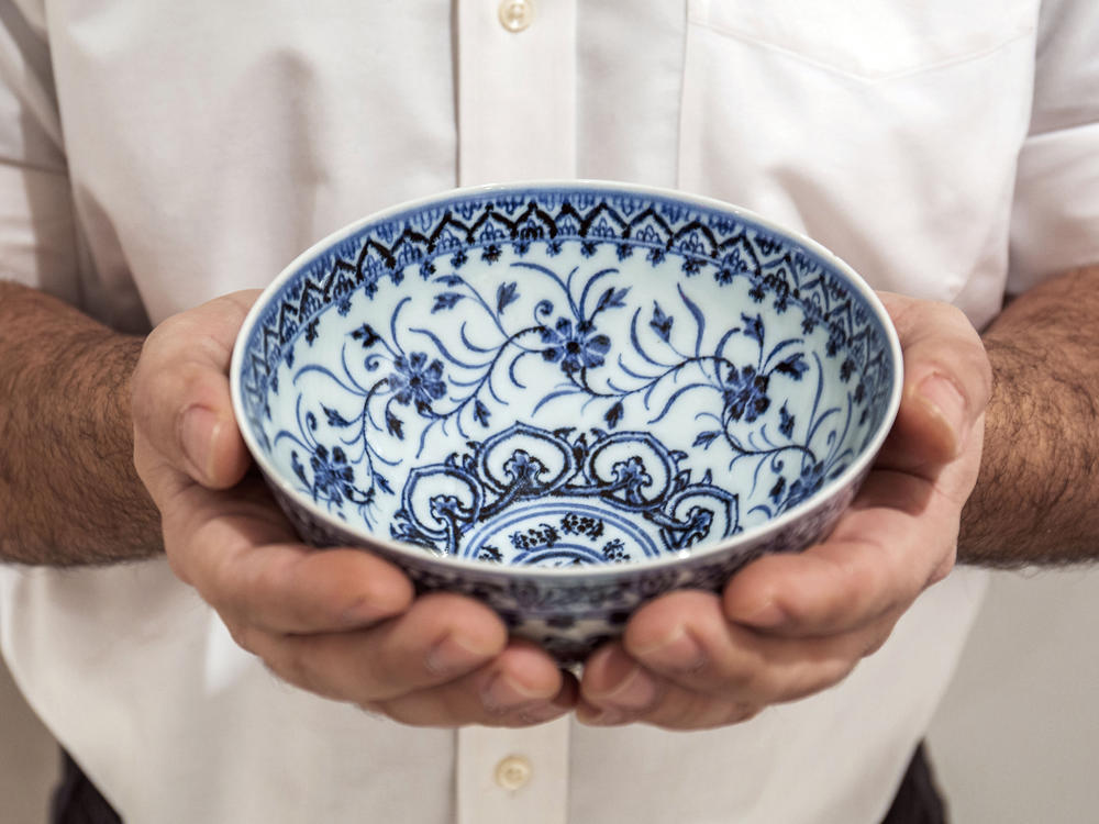 A small porcelain bowl, pictured in a photo provided by Sotheby's, cost $35 at a yard sale but was later identified as a rare, 15th-century Chinese artifact worth between $300,000 and $500,000.