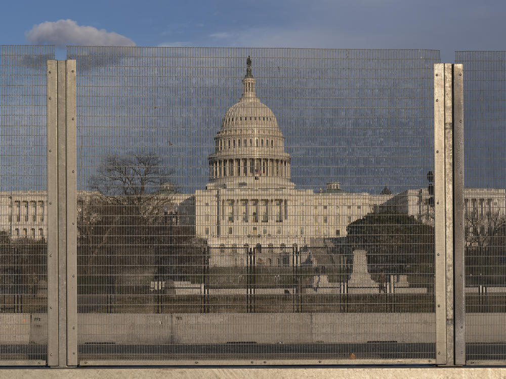 A section of fencing blocks the Capitol grounds at sunset on Monday.