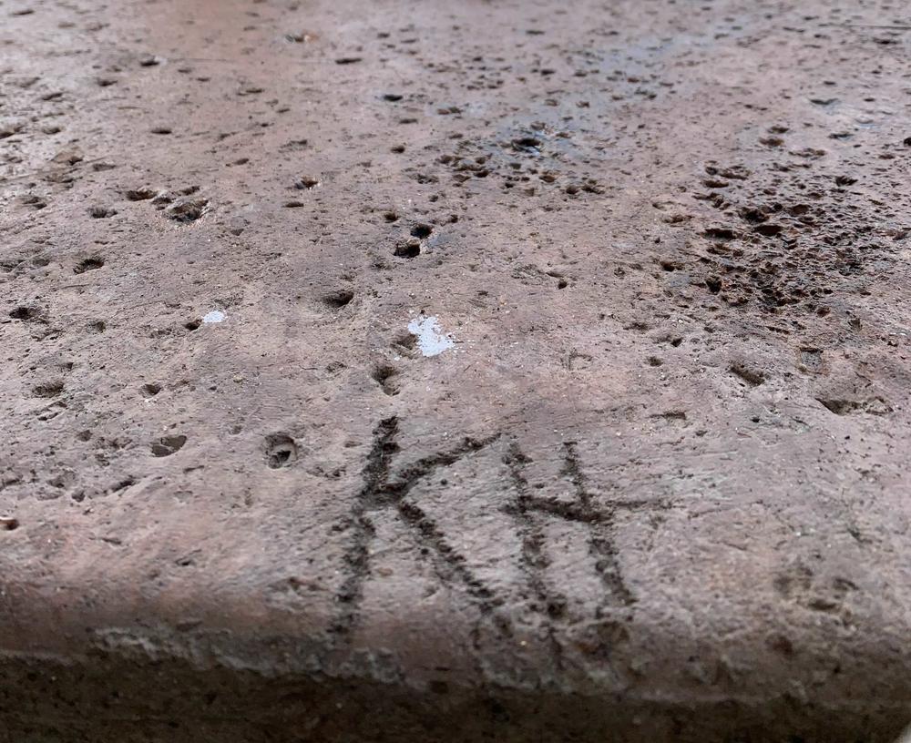 Hawari's initials on a sidewalk in what is known informally as 