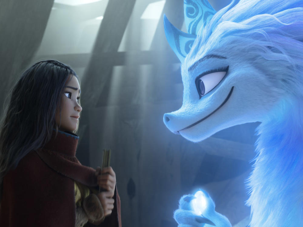 Raya, a young warrior princess (Kelly Marie Tran), enlists the help of Sisu, a friendly water dragon (Awkwafina) in <em>Raya and the Last Dragon. </em>