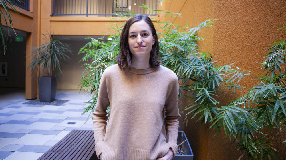Brigitte Driller, 30, stands in the courtyard of her apartment building near downtown Sacramento. She would love to buy a home in the city but feels priced out.