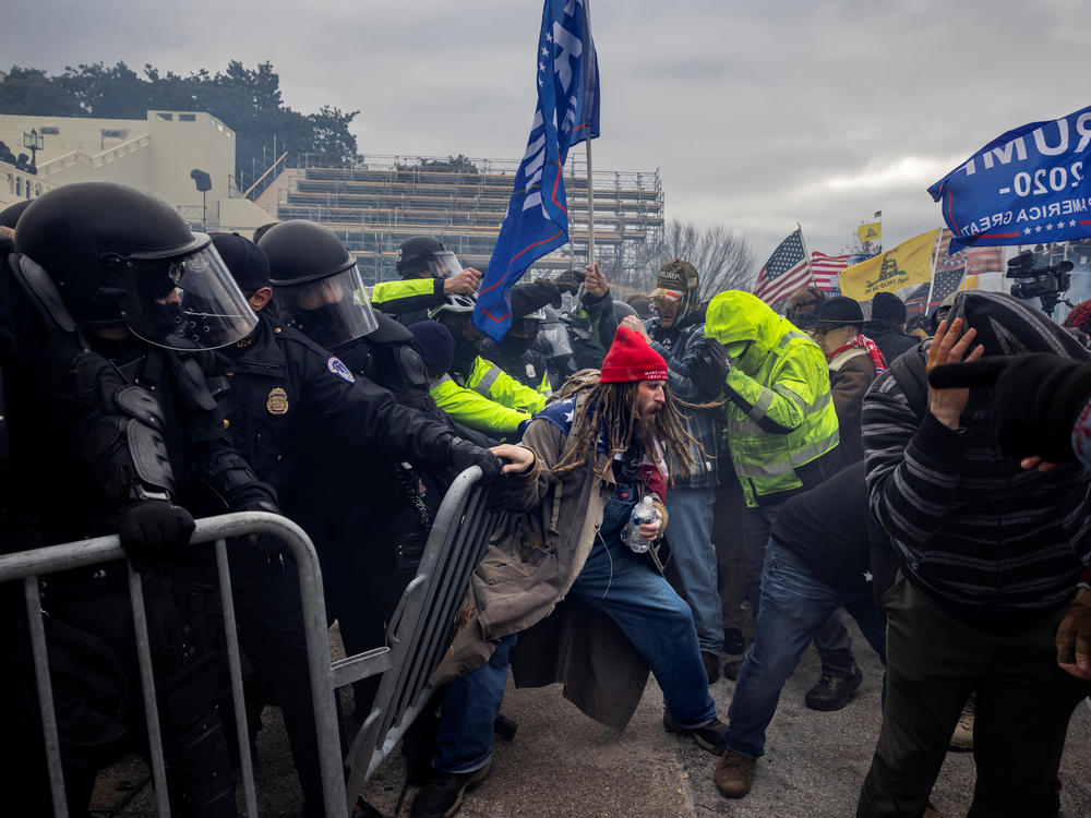 Trump supporters clash with police outside the U.S. Capitol on Jan. 6. Social media companies are under scrutiny for allowing their platforms to be used to spread falsehoods about the 2020 election and to allow violent extremist groups to organize January's insurrection.