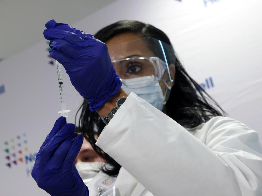 A medical worker at South Shore University Hospital gets ready to administer the newly available Johnson & Johnson COVID-19 vaccine in Bay Shore, N.Y., Wednesday. Clinical research found it to be 85% effective in preventing severe disease four weeks after vaccination, and it has demonstrated promising indications of protection against a couple of concerning variants of the coronavirus.