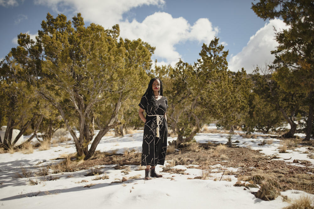 Ifeoma Ozoma stands outside her home in Santa Fe, N.M.