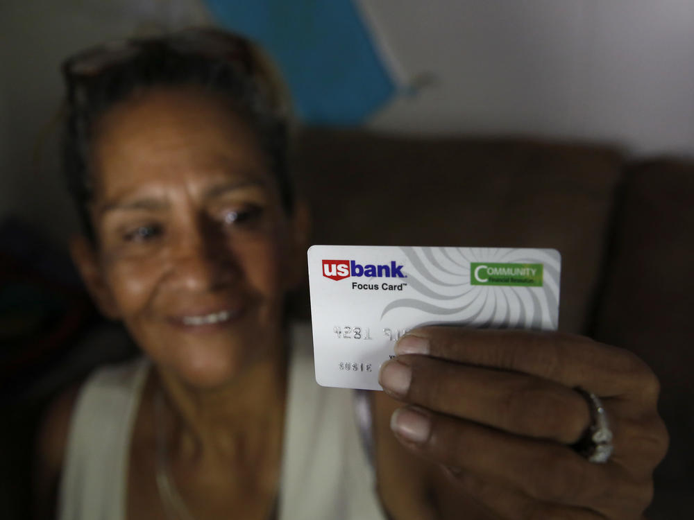 Stockton, Calif., resident Susie Garza displays the debit card on which she received a monthly stipend as part of a pilot universal basic income program. The program began in 2019, when this photo was taken.