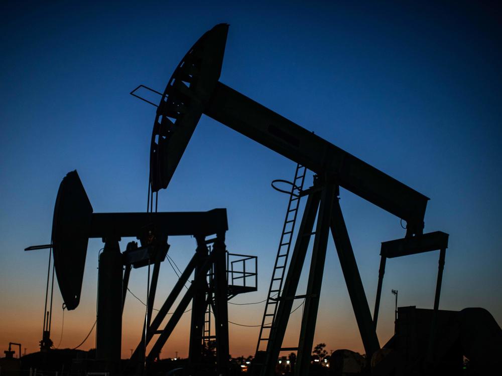 Oil pump jacks operate at dusk in Long Beach, Calif., on April 21, 2020. After getting burned by the oil industry's previous boom-and-bust cycles, Wall Street now wants energy companies to pump less crude, not more.