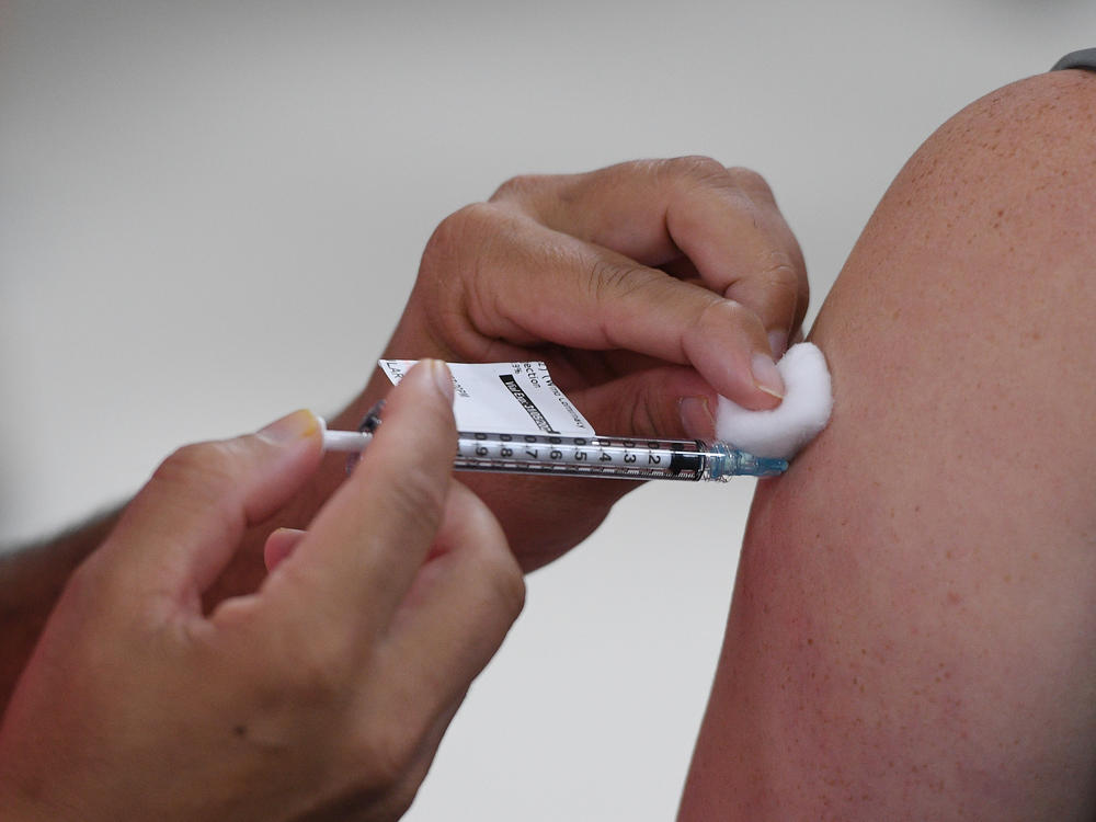 A health care worker in Sydney, Australia receives their COVID-19 vaccination this month. Italian authorities got the European Commission to block a shipment of 250,700 doses of vaccine destined for Australia from Europe this week.