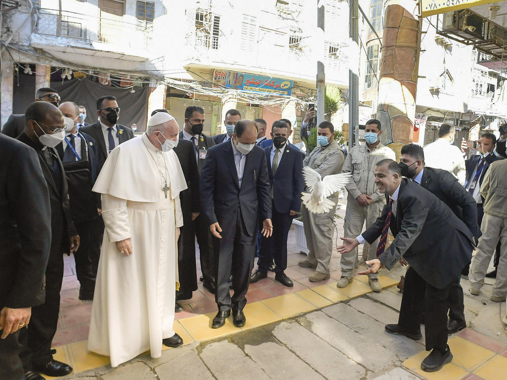 A white dove, a symbol of peace, is made to fly in front of Pope Francis as he arrives to a meeting with Iraq's leading Shiite cleric, Grand Ayatollah Ali al-Sistani in the Iraqi city of Najaf.