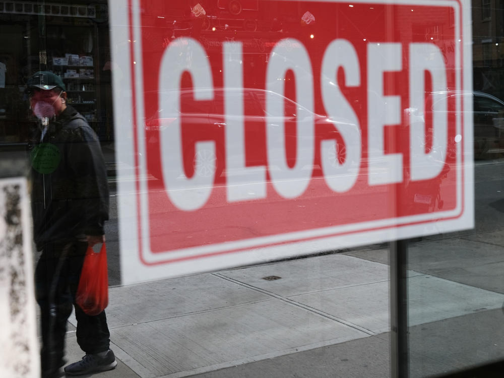 A store in New York City stands closed on April 21, 2020. A year after the coronavirus pandemic was declared, millions of Americans are still unemployed.