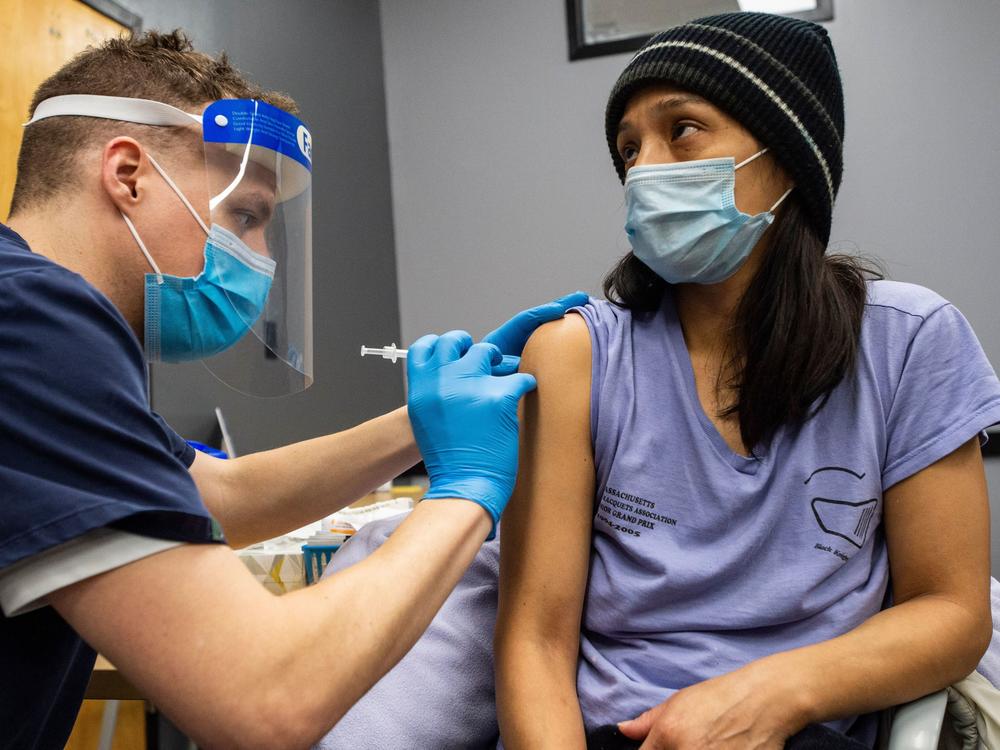 Edith Arangoitia receives a COVID-19 vaccination in Chelsea, Mass., a heavily Hispanic community, on Feb. 16.