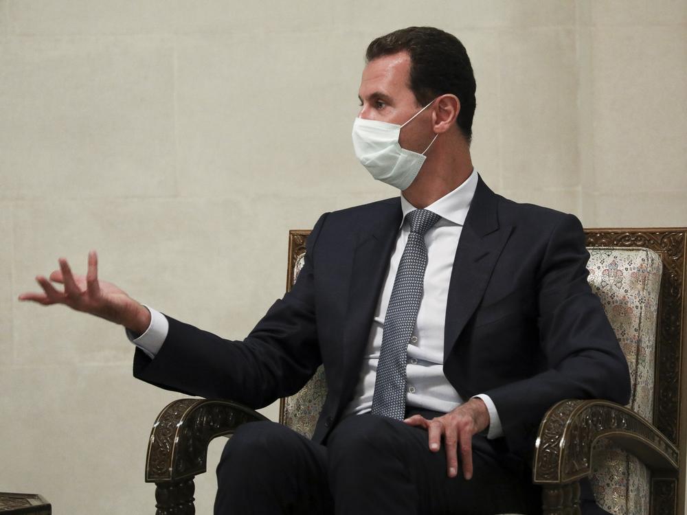 Syrian President Bashar Assad gestures while speaking to Russian Foreign Minister Sergey Lavrov during talks in Damascus in September. Assad and his wife, Asma, have been diagnosed with coronavirus infection, according to an official statement.