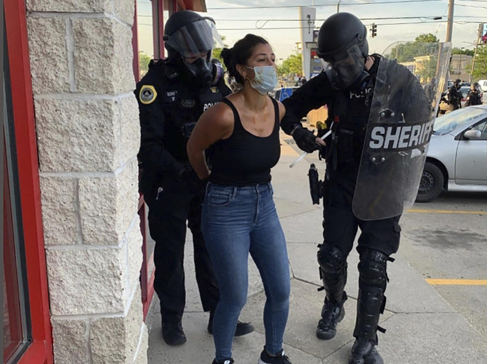 Police officers are shown arresting <em>Des Moines Register</em> reporter Andrea Sahouri after a Black Lives Matter protest she was covering on May 31, 2020, in Des Moines, Iowa. Sahouri went on trial Monday on charges of failing to disperse and interfering with official acts.