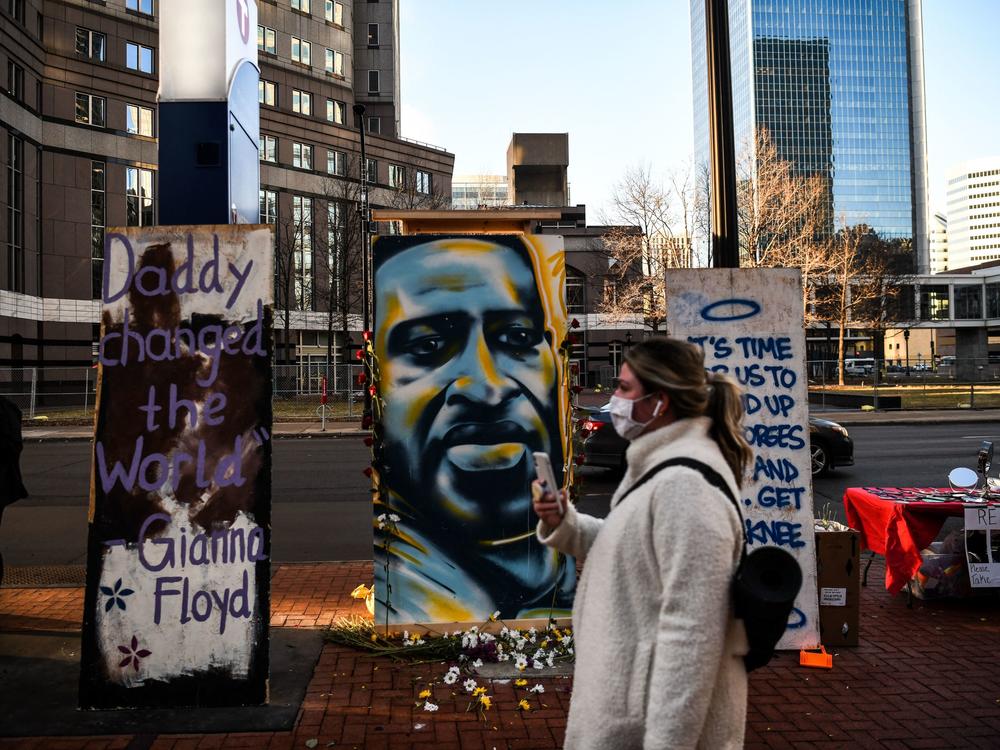 Hennepin County Judge Peter Cahill sent potential jurors in Derek Chauvin's trial home on Monday. Here, a painting of Floyd is seen outside the Hennepin County Government Center, where the trial is taking place.