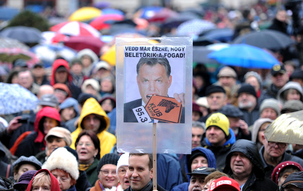 Employees and sympathizers of Hungary's Klubradio hold an image of Hungarian Prime Minister Victor Orban biting the independent radio station's logo, in Budapest on Feb. 24, 2013, during a demonstration for freedom of speech.