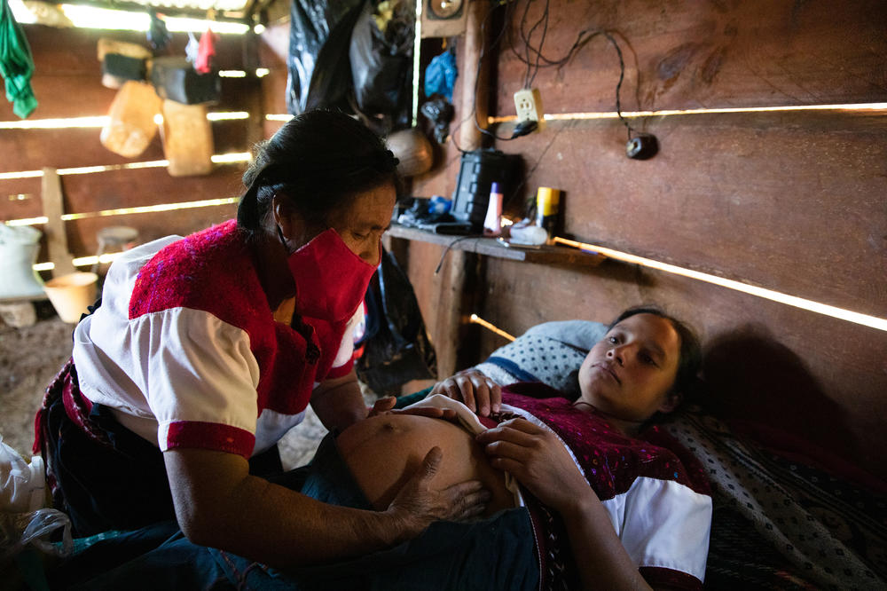 Midwife Petrona Hernández Díaz performs a pandemic prenatal checkup on Ana Laura Gómez Hernández.