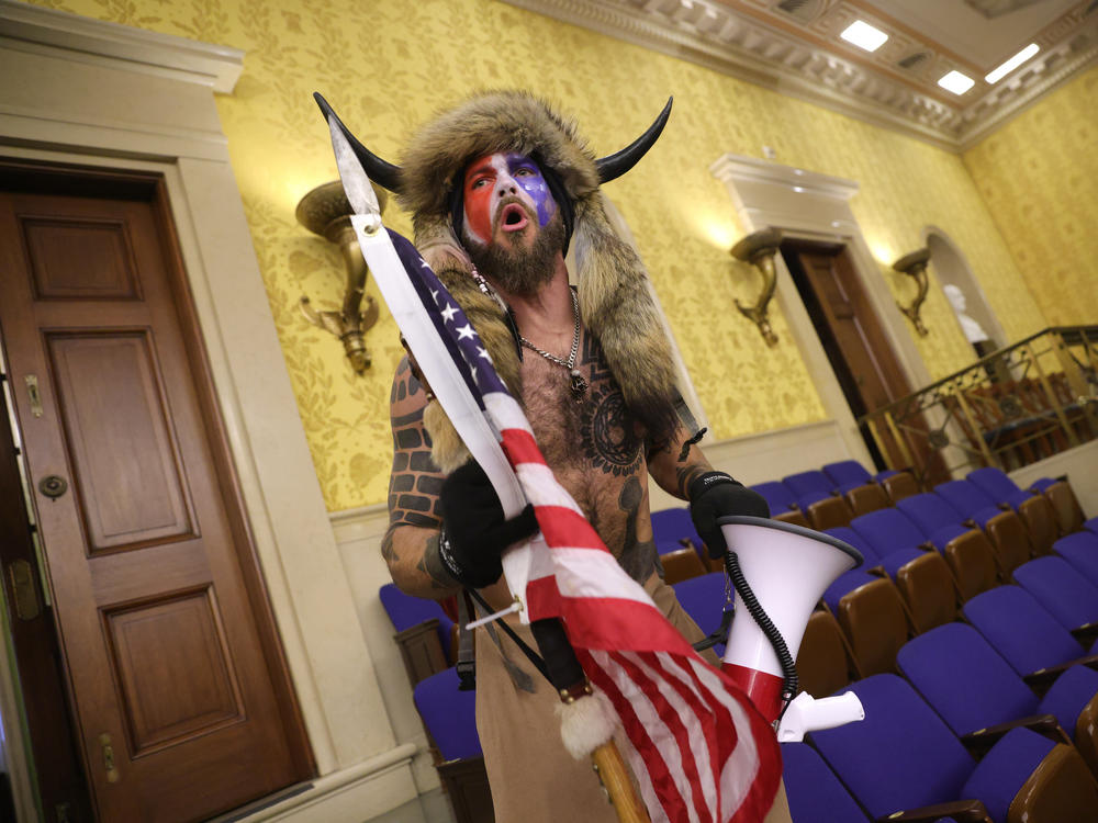 Jacob Chansley, photographed during the Jan. 6 U.S. Capitol insurrection, screams 