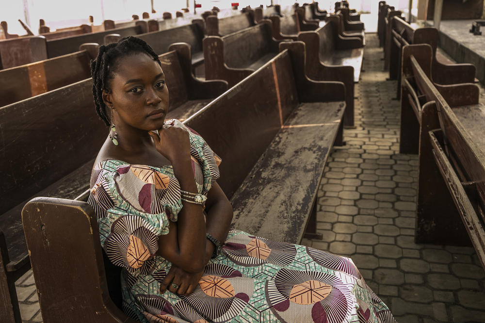 Dr. Henang Kwasau, 30, sits in the church where she's found lodging during her internship at a hospital in Lagos, Nigeria. The photo was taken on February 21, 2021.