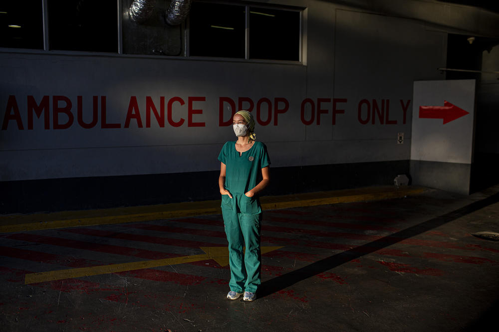 Emergency medical medical officer Dr. Storm Bissict, 35, photographed outside the ER entrance of Netcare Christiaan Barnard Memorial Hospital, Cape Town, South Africa, on the morning of January 19. To escape the stresses of her job during a pandemic, she dives into the ocean.
