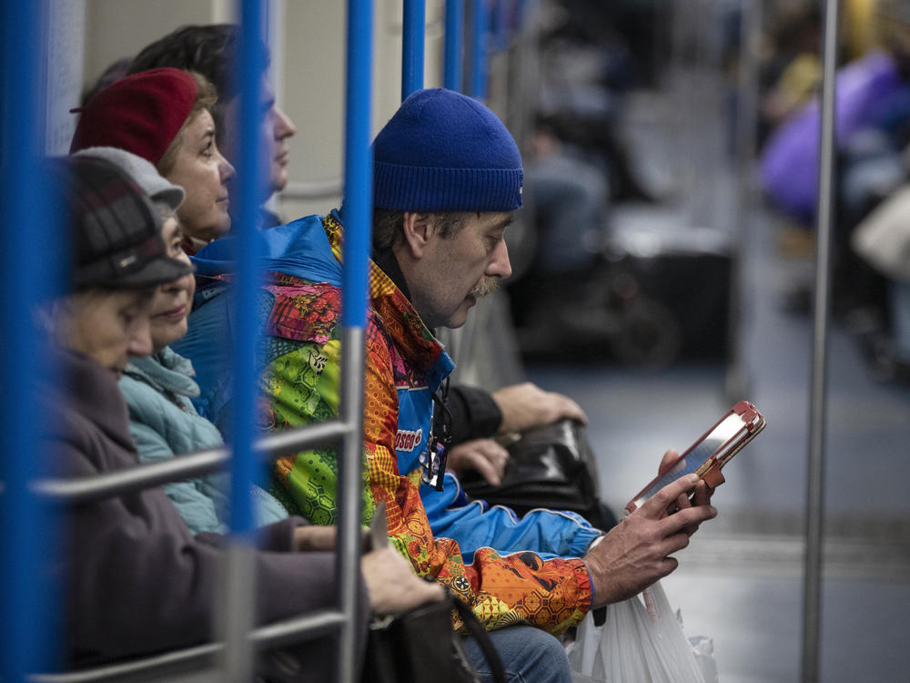 A man uses a tablet device in a subway train in Moscow in 2019. Russia's Internet regulatory agency announced it is slowing Twitter because the company has ignored requests to remove content harmful to children.