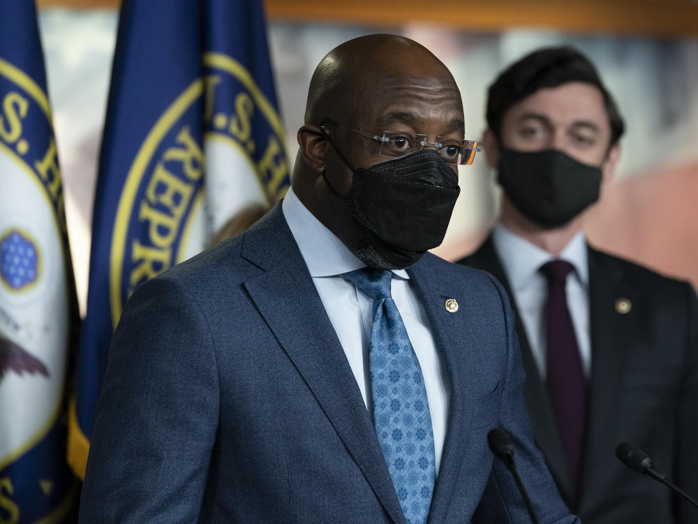 Sen. Raphael Warnock, D-Ga., left, accompanied by Sen. Jon Ossoff, D-Ga., speaks during a news conference, before the vote on the Democrat's $1.9 trillion COVID-19 relief bill on March 10, 2021.