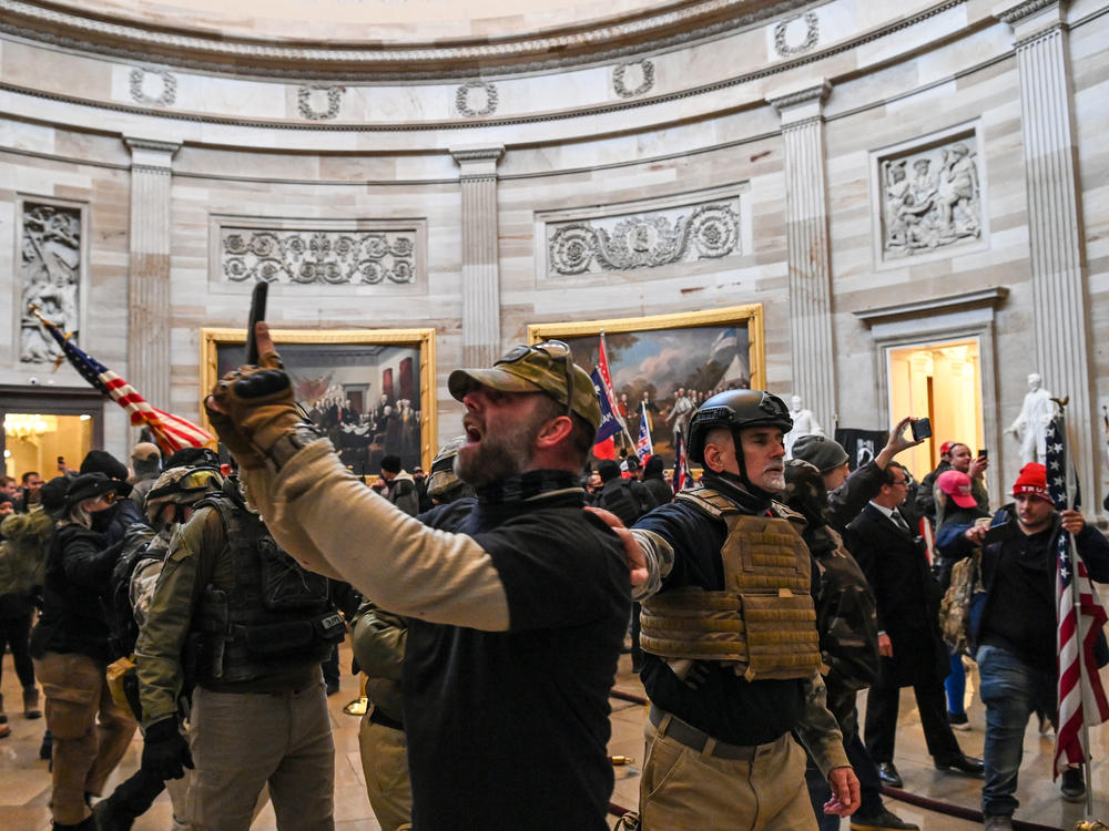 Kenneth Harrelson, identified in an FBI affidavit as the man at center holding a phone in the Capitol Rotunda, is charged with obstructing an official proceeding, destruction of government property, entering a restricted building and conspiracy.