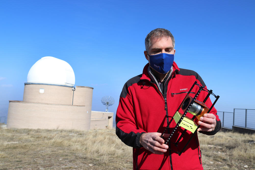 Montsec Observatory Director Josep Colomé holds a replica of a nanosatellite. Catalonia plans to launch up to six of these as part of its new space agency, to improve mobile networks and observe the Earth from space.