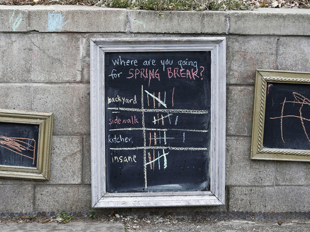For lighter moments during the coronavirus pandemic, passersby had an opportunity to vote for their stay at home spring break moments on the retaining wall of a home in St. Paul, Minn.