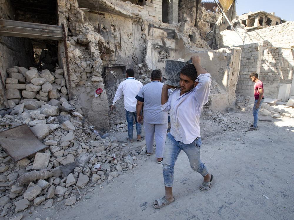 Volunteers clear the Old Market district of debris in Aleppo, Syria, in 2019. Years of fighting have left many sections of Aleppo destroyed.