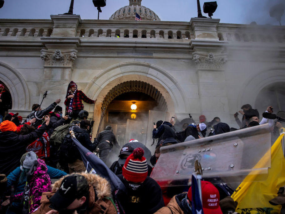 Pro-Trump rioters clash with police and security forces as people storm the U.S. Capitol on Jan. 6. Federal investigators say they expect even more people will be charged in connection with the insurrection.