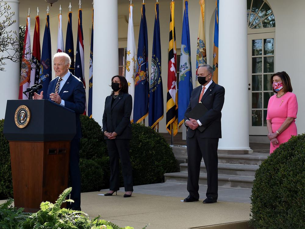 President Biden, with (L-R) Vice President Kamala Harris, Senate Majority Leader Chuck Schumer, and House Speaker Nancy Pelosi, Democrat of California, speaks about the American Rescue Plan in the Rose Garden of the White House on Friday.