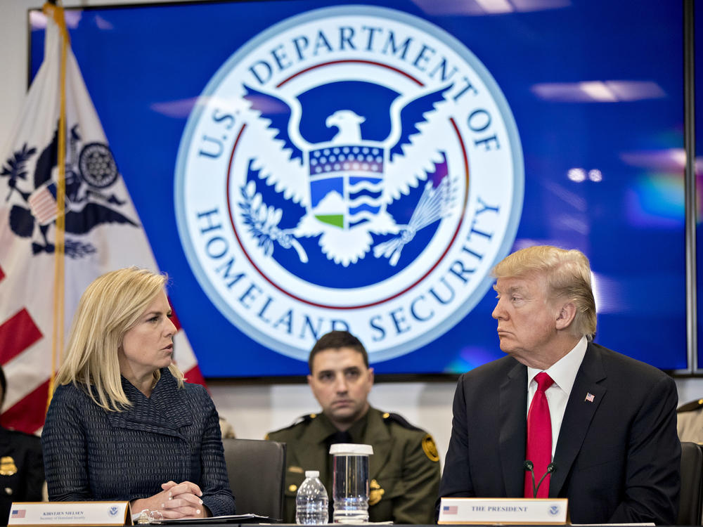 Then-President Donald Trump and the Homeland Security secretary at the time, Kirstjen Nielsen, speak during a Customs and Border Protection roundtable in Virginia in 2018. The Biden administration rescinded an agreement from that time between the Homeland Security and Health and Human Services departments that it says hampered efforts to find safe homes for unaccompanied minors.