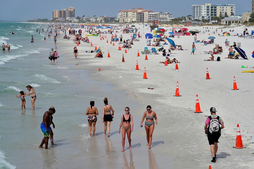 Beachgoers take advantage of the weather as they spend time on Clearwater Beach Tuesday, March 2, in Clearwater, Fla., a popular spring break destination, west of Tampa. Colleges around the U.S. are scaling back spring break or canceling it entirely to discourage beachfront partying that could raise infection rates back on campus.