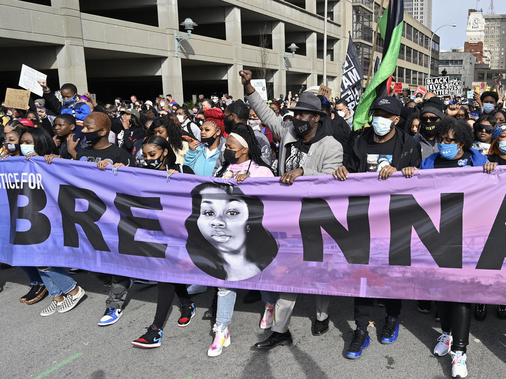 Tamika Palmer (center), the mother of Breonna Taylor, leads a march through the streets of downtown Louisville on the anniversary of Taylor's death on Saturday.