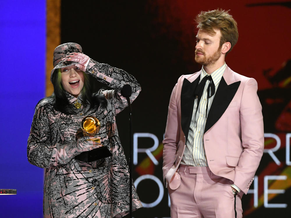 Billie Eilish (left) and FINNEAS accept the Record of the Year award for Eilish's song 