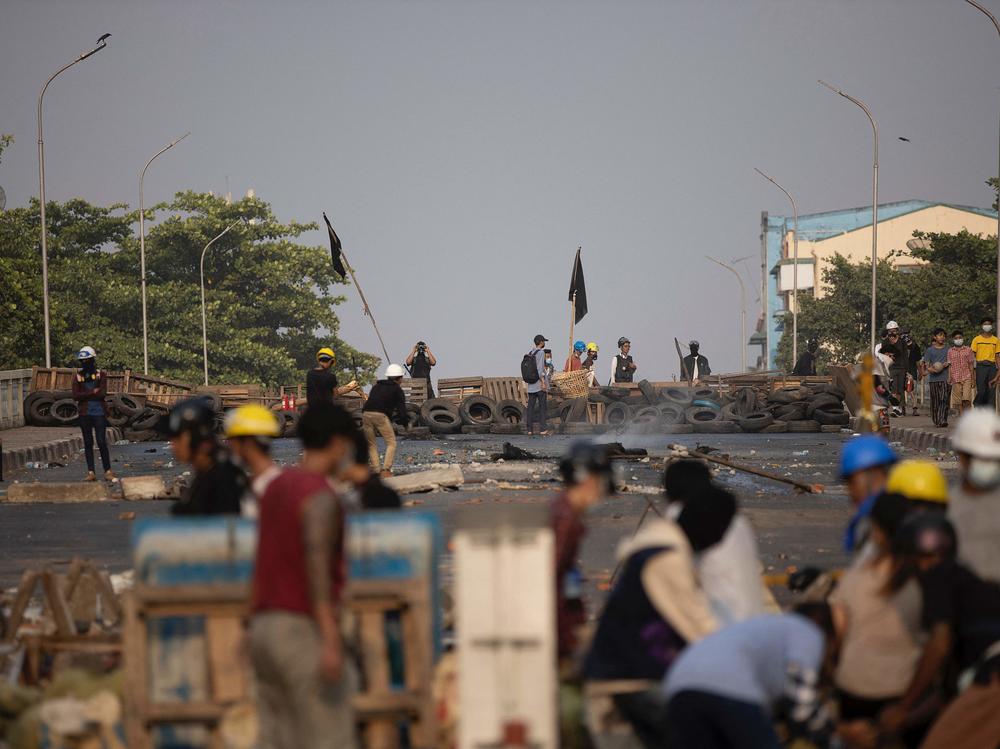 Protesters in Yangon, Myanmar, stand near makeshift barricades during demonstrations against the country's military coup.