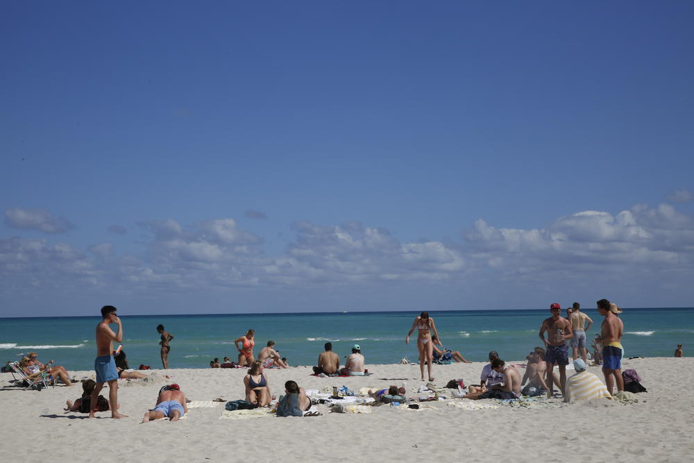 Students vacationing in Miami Beach told NPR they decided to travel despite their colleges cancelling spring break. Many are still attending online classes and taking exams from their hotel rooms.