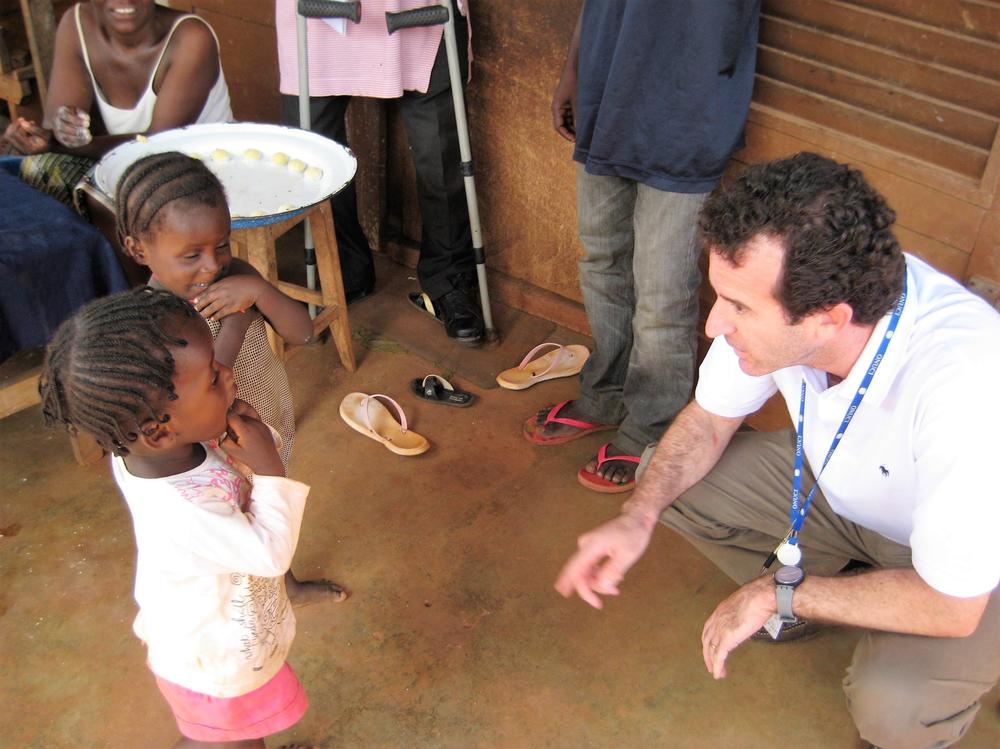 Dr. Paul Spiegel greets children displaced by conflict in Ivory Coast while undertaking an assessment mission in 2017.