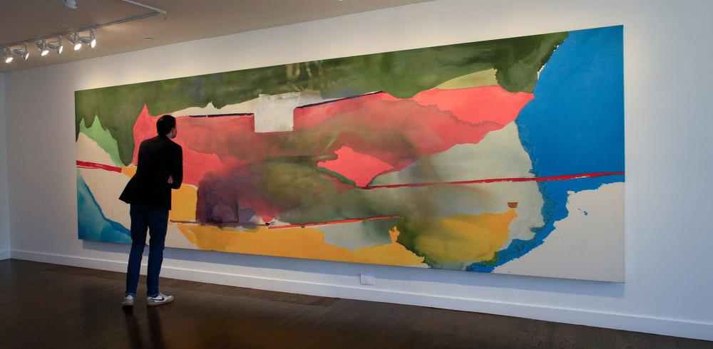 A visitor looks at Helen Frankenthaler's <em>Off White Square </em>(1973) at a gallery in Southampton, N.Y.