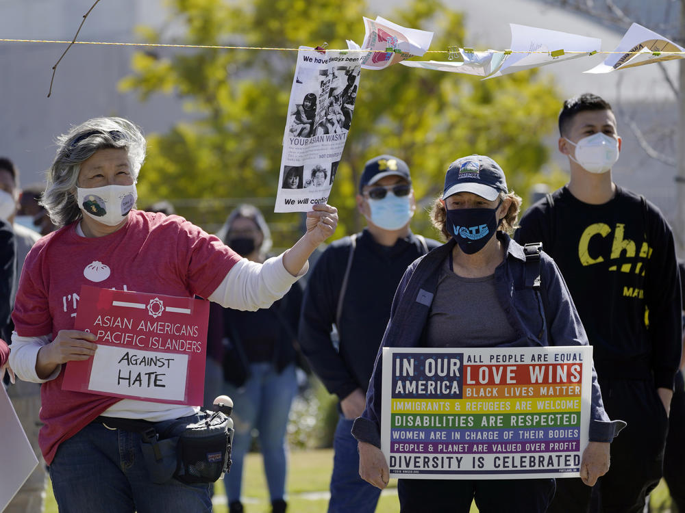 People attend a community rally to raise awareness of anti-Asian violence and racist attitudes, held at Los Angeles Historic Park near the Chinatown district in Los Angeles, Saturday, Feb. 20, 2021.
