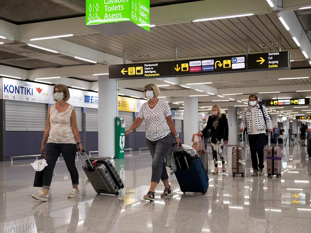 Tourists arrive at Palma de Mallorca, Spain, last summer. The EU's executive arm has proposed a certificate to ease travel across its member states.